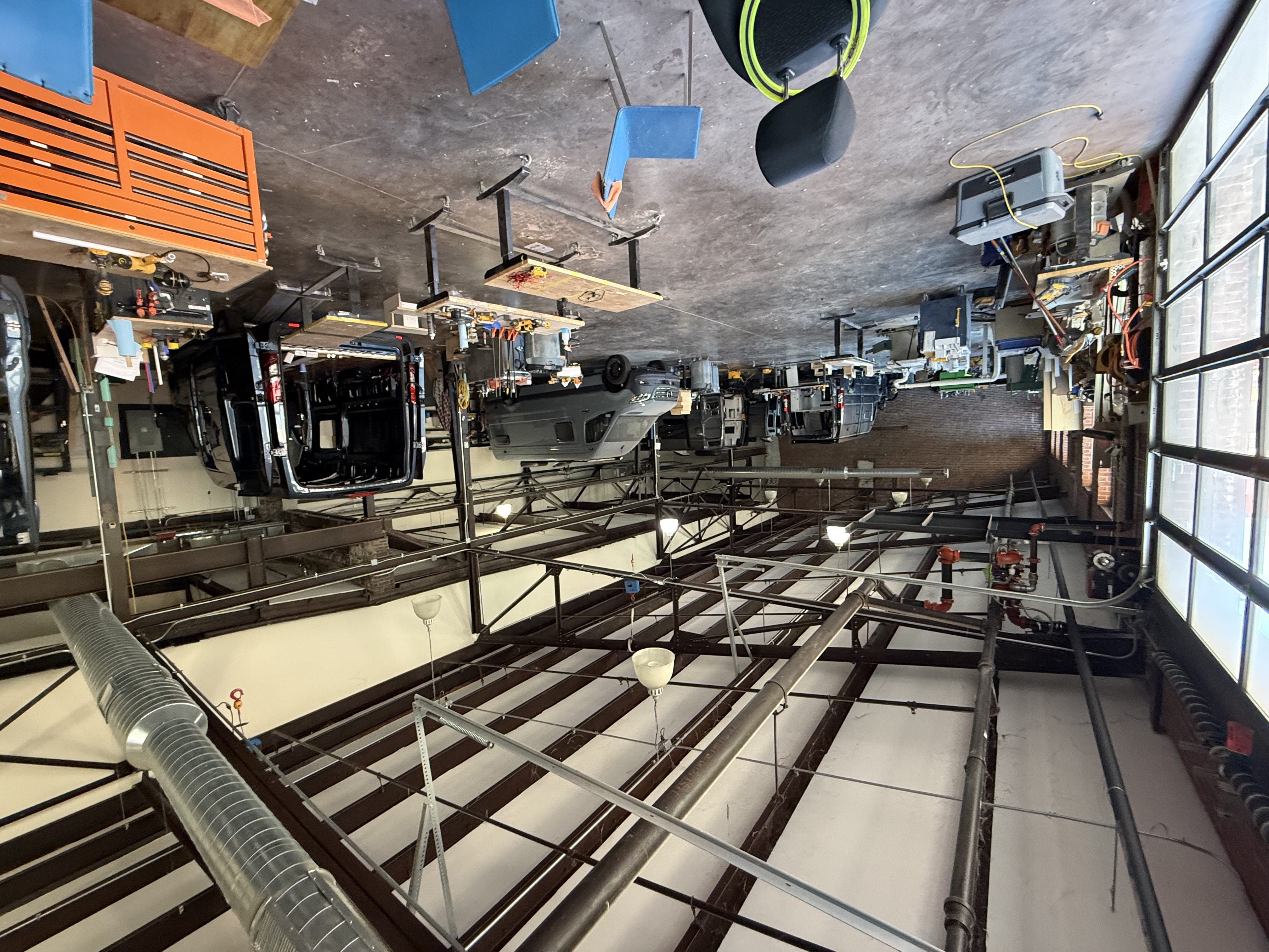 Interior of the Ready.Set.Van. main shop with vans, work tables, and overhead steel structure.